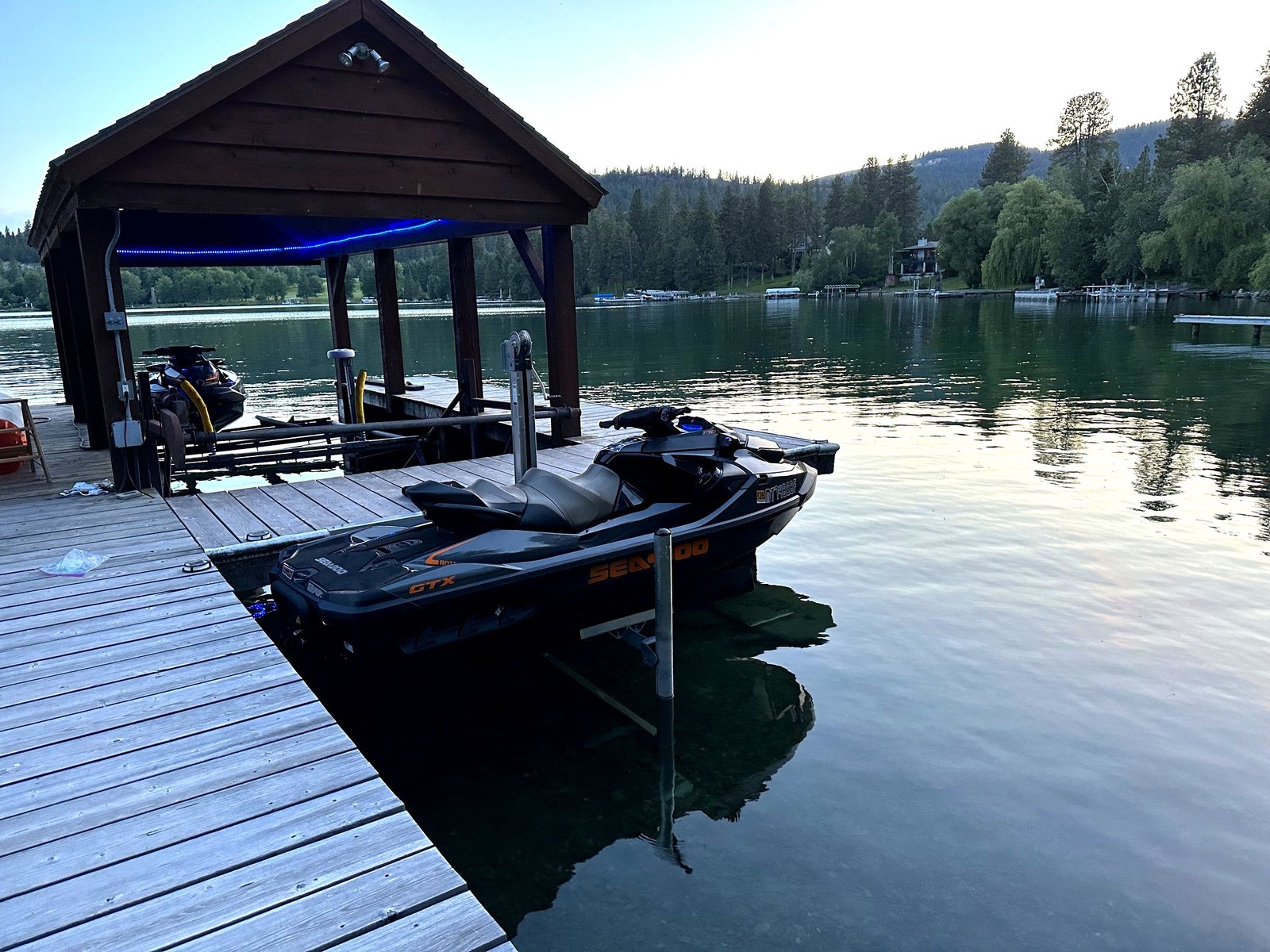 Private dock with boats at Eagle's Bluff Lakeside House on Flathead Lake