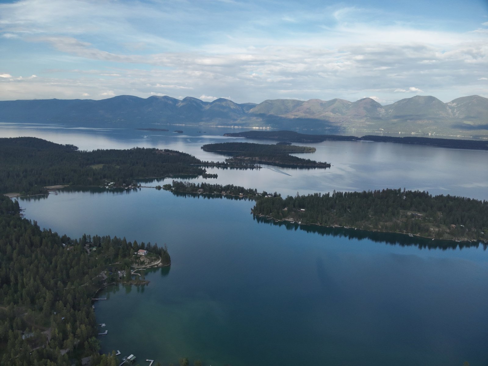 Summer aerial of Eagle's Bluff luxury estate on Flathead Lake with lush green grounds