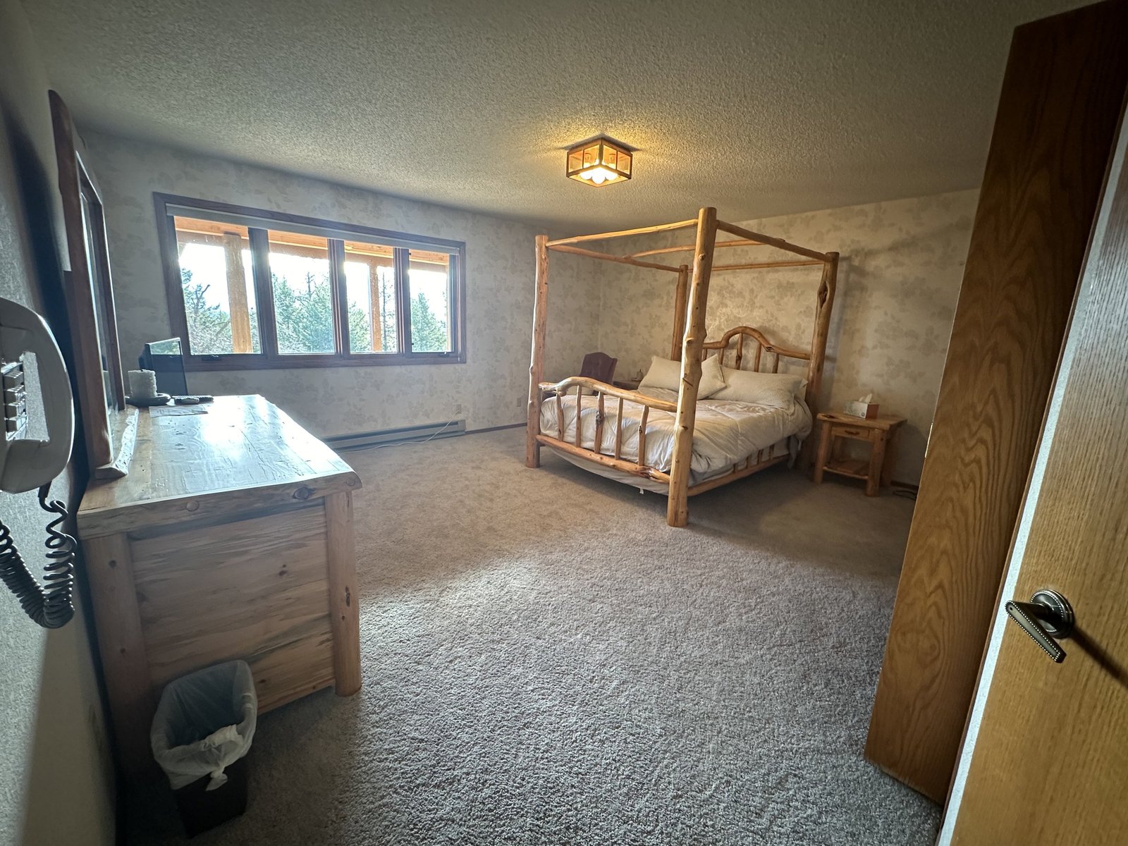 Spacious bedroom in Eagle's Bluff Main House with mountain views near Polson, Montana