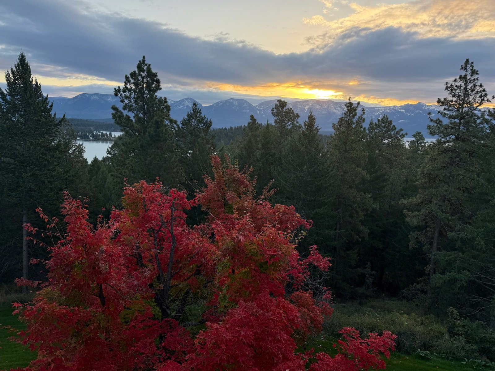 Eagle's Bluff Main House exterior with Flathead Lake and Montana sky backdrop